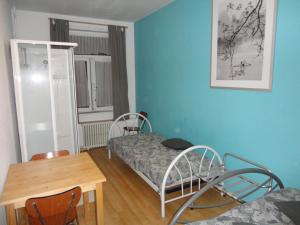 布兰肯贝赫罗基斯龙岛酒店的小房间设有一张床、一张桌子和椅子