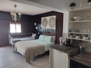 埃尔帕索Hacienda FELIX的一间卧室配有一张床铺和一张桌子,还设有一间厨房