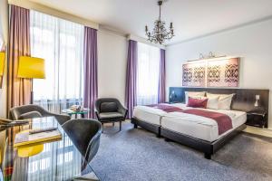 哥本哈根斯堪迪克皇宫酒店的配有一张床和一把椅子的酒店客房