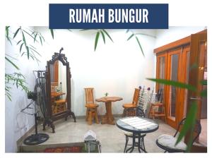 KalasanRumah Bungur, Purwomartani的配有桌子、椅子和桌子的房间