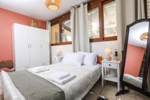 卡诺尼ΒeΙΙa的卧室配有白色的床和镜子