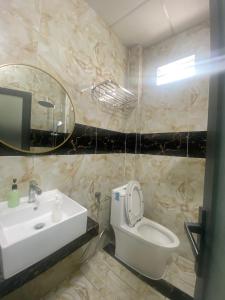 Hoi NghiaKhách Sạn Hội Nghĩa Bình Dương的一间带水槽、卫生间和镜子的浴室