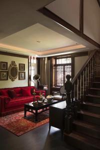 杭州杭州秋水山庄的一间带红色沙发的客厅和楼梯
