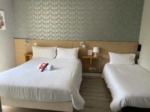比亚里茨欧克索酒店的酒店客房,配有两张床,床上有一只动物塞满了东西