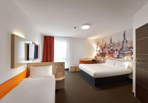 卢布林B&B Hotel Lublin Centrum的一间酒店客房,设有两张床和电视