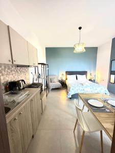阿齐亚佩拉加Brand new studio Sea View的厨房以及带1张床和1张桌子的卧室