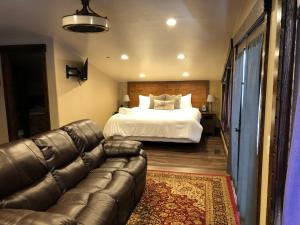 HildaleZion Cliff Lodge的客厅配有床和真皮沙发