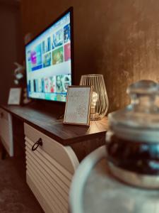 克拉列沃Apartman Puket的一张桌子,上面有电视,上面有标志