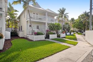 鸭礁岛Palm Villa的棕榈树和人行道的白色房子