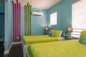 迈阿密海滩住宿加饮品酒店的蓝色和黄色的客房内的两张床