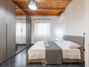 贡内萨Floris Modern House的一间卧室设有一张带木制天花板的大床
