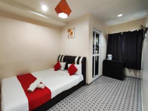 丹那拉打Ar Rayyan Hotel的一间卧室配有红色和白色枕头的床