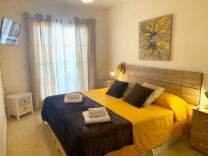 米哈斯科斯塔Dream Apartment in Mijas Golf Limonar的一间卧室配有一张大床和两条毛巾