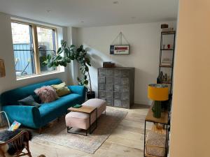 布里斯托Ideal Bristol getaway - 3 bed harbourside home的客厅配有蓝色的沙发和桌子