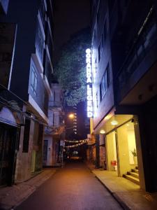 河内Granda Legend Apartment的夜间有灯光标志的城市街道