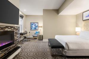 丹佛丹佛白玉兰酒店 - 翠贡精选酒店的配有一张床和一台平面电视的酒店客房