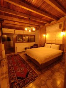 阿瓦诺斯Begam Butik Otel的一间卧室配有一张大床和地毯。