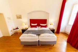 海德堡Hotel zum Ritter St. Georg的一间卧室配有一张红色床头板的床