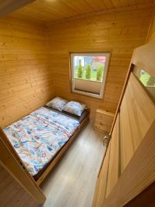 弗瓦迪斯瓦沃沃Domki letniskowe Na Stoku的小木屋内的小房间,配有一张床
