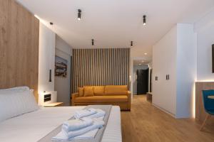 雅典A&N Athens Luxury Apartments - Ermou的一间卧室配有一张床和一张沙发