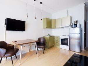 奥斯陆城市中心公寓的厨房配有桌椅和冰箱。
