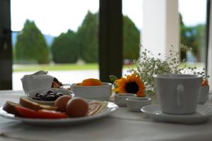 拉米亚Fthia Hotel的一张桌子,上面放着一盘食物和咖啡杯