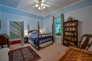 塔斯卡卢萨Firefly Garden的一间卧室设有一张床和一个书架