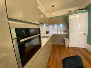 伦敦Kings Cross Apartment的厨房配有冰箱和炉灶。 顶部烤箱