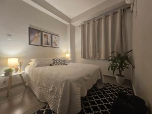 安格拉杜斯雷斯CASA_ESTRELA的一间卧室配有一张床和盆栽植物