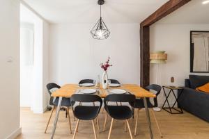 桑坦德Apartamento de diseño en el corazón de Santander的一间带木桌和椅子的用餐室