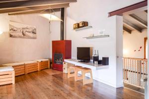 贝萨卢CAN FRUITÓS Alojamiento rural en Besalú的客厅配有电视和书桌及电视
