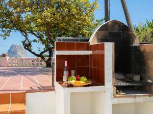 拉坎努塔卡尔普别墅的砖炉,上面放着一盘蔬菜和一瓶葡萄酒