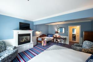 肯尼邦克港肯尼邦克港酒店的酒店客房配有一张床和一个壁炉。