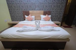 马图拉Hotel Mukund Priya- Near Krishna Janam Bhoomi的一张带两个白色毛巾的床