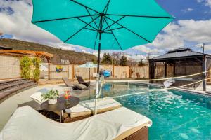 克拉马斯福尔斯Casa Del Moro Klamath Falls Apt Pool and Hot Tub!的一个带桌子和遮阳伞的游泳池