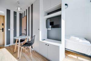 索波特Carbon by OneApartments的卧室配有一张床和一张桌子及椅子
