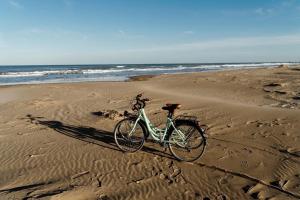 卡马尔莱斯Caseta De L'avi的停在海边沙滩上的自行车