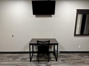 弗拉格斯塔夫Hotel West Inn NAU - Downtown Flagstaff的一张黑桌,墙上有电视