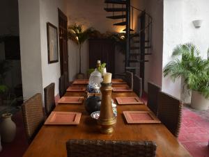 圣玛尔塔Casa Gaitana - Alma Hotels的一张长木桌子,位于带椅子的房间