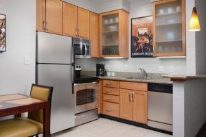 本殖民地Residence Inn by Marriott Dallas Plano The Colony的厨房配有不锈钢用具和木柜