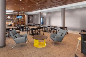 格林伍德村SpringHill Suites by Marriott Denver Tech Center的一间带桌椅和黄色桌子的餐厅
