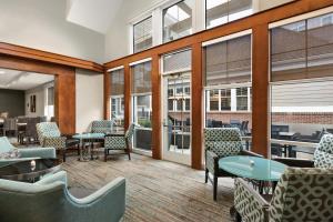 米德尔敦Residence Inn by Marriott Newport Middletown的一间设有桌椅和窗户的等候室