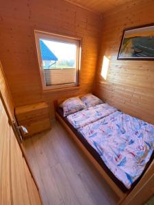 弗瓦迪斯瓦沃沃Domki letniskowe Na Stoku的小木屋内一间卧室,配有一张床
