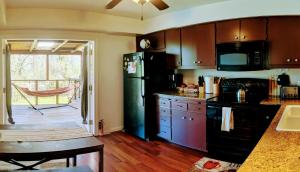奥克赫斯特Wona's 2 bedrooms full kitchen的厨房配有黑色冰箱和桌子