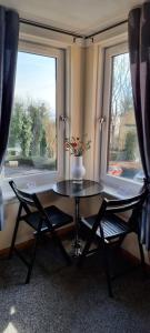 法夫Faodail, 1 Bed Studio apartment at Ravenscraig Castle and Park的窗户间里的一张桌子和两把椅子
