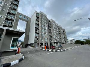 瓜埠Langkawi Simfoni Beliza Apartment with Sky Pool by Zervin的一个空的停车场,有两个高的公寓楼