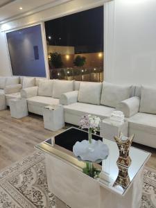 哈伊勒شاليه البستان حي المنتزه الغربي的客厅配有白色的沙发和桌子