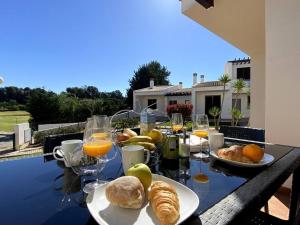 阿尔沃尔Golf Villa Alvor By CORAL的一张桌子,上面放着面包、橘子和橙汁