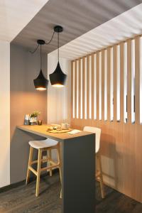 蒙得维的亚Moderno apartamento en Punta Carretas的厨房配有桌子、两把椅子和两盏灯