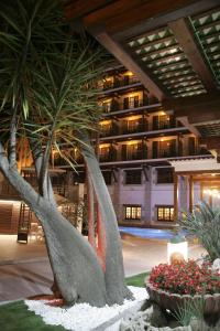 罗列特海岸Hotel La Carolina的一座建筑中两棵棕榈树的雕塑